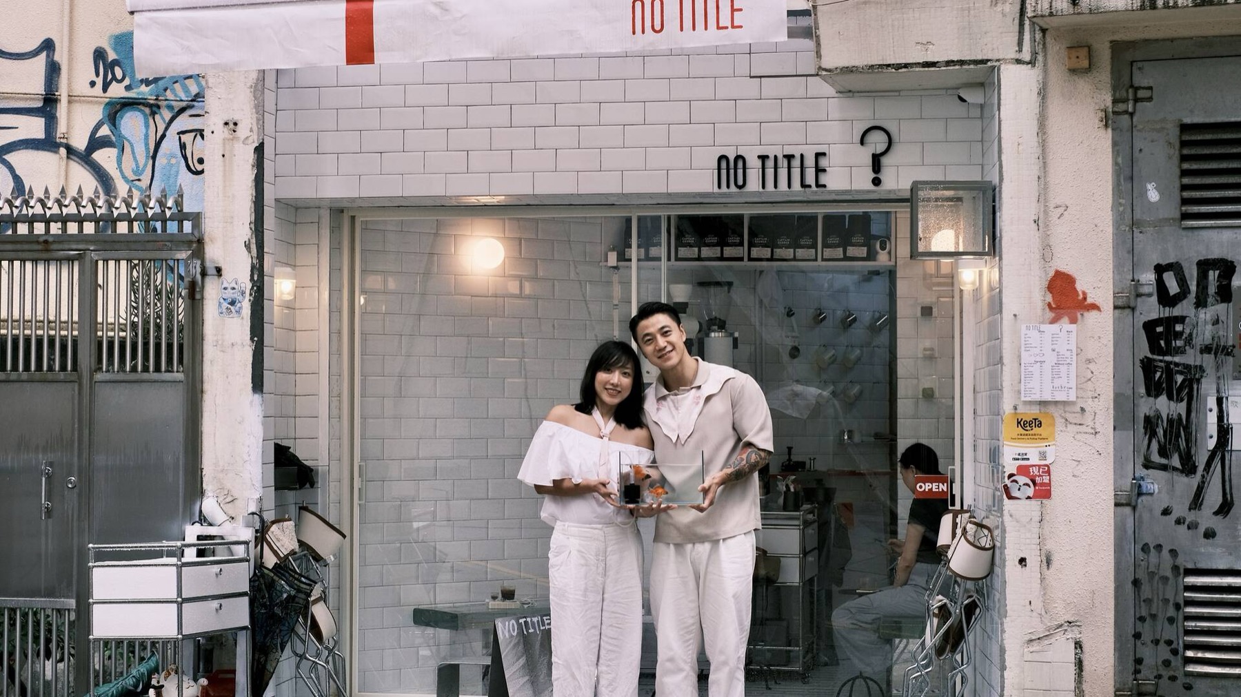 The No Title Coffee founders standing outside the shop with drinks